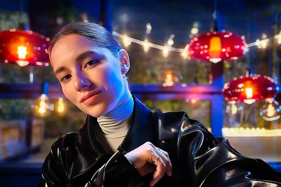 A photo of woman in low light conditions.